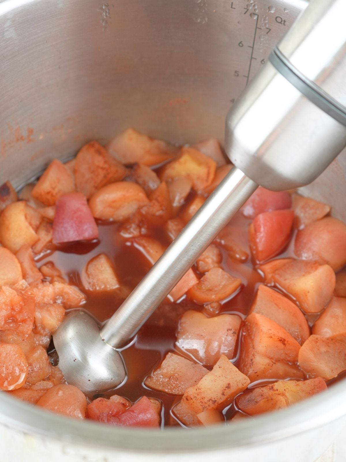 Cooked apples ready for blending into apple butter. Shown with an immersion blender.