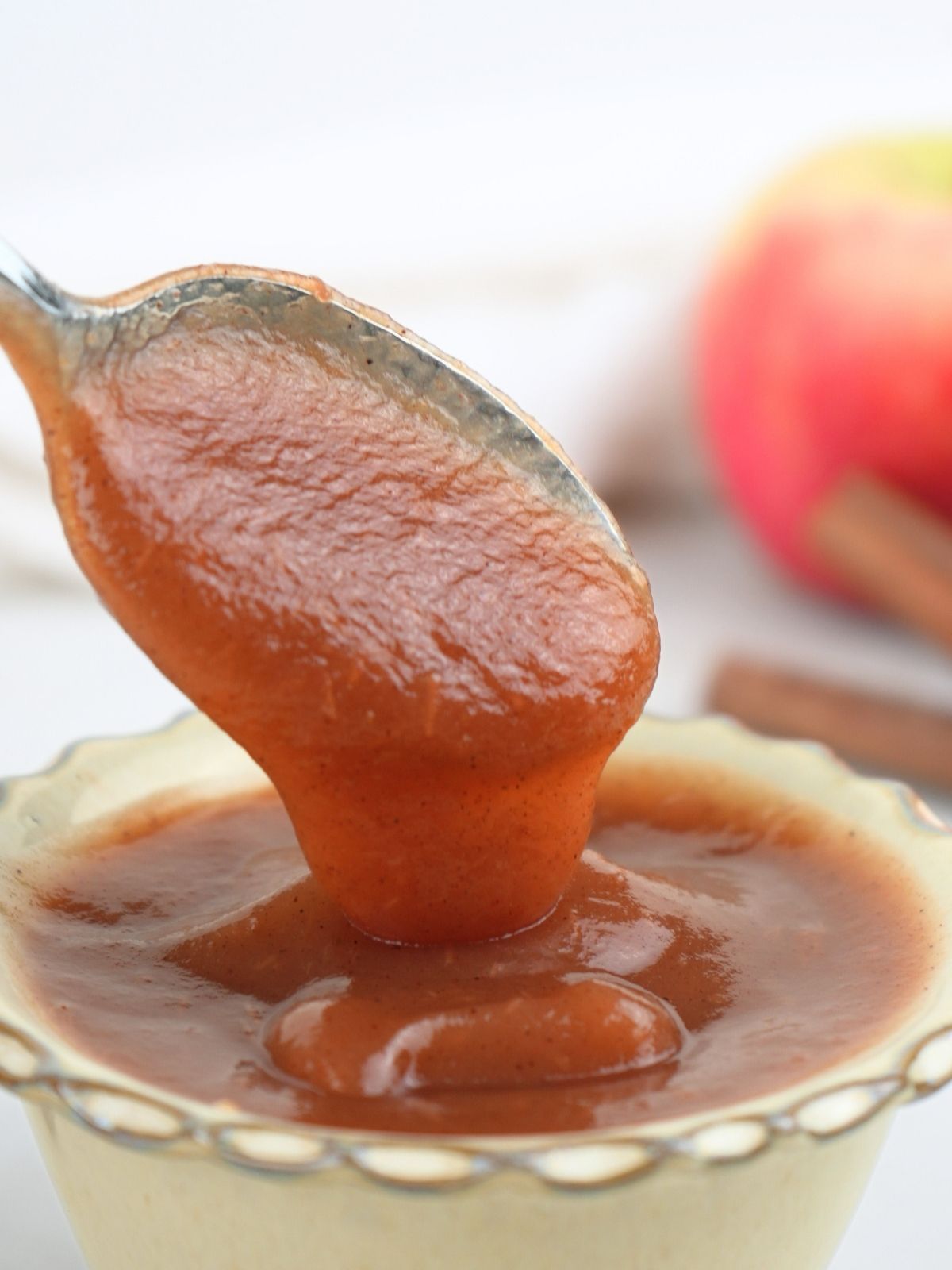 Instant Pot apple butter on a spoon.