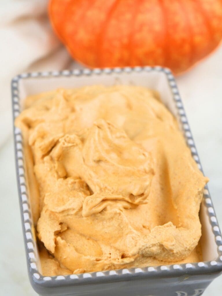 Homemade pumpkin ice cream in a container for freezing.