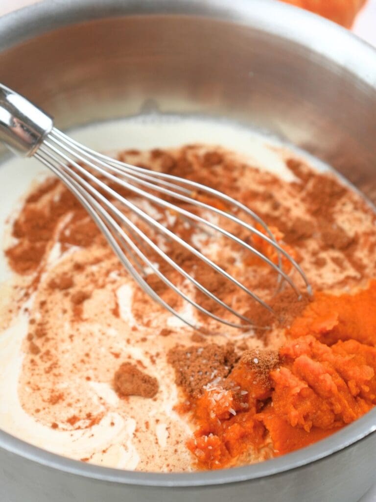 Pumpkin ice cream base ingredients in a sauce pot.