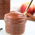 A small jar of Instant Pot apple butter with a gold knife it in