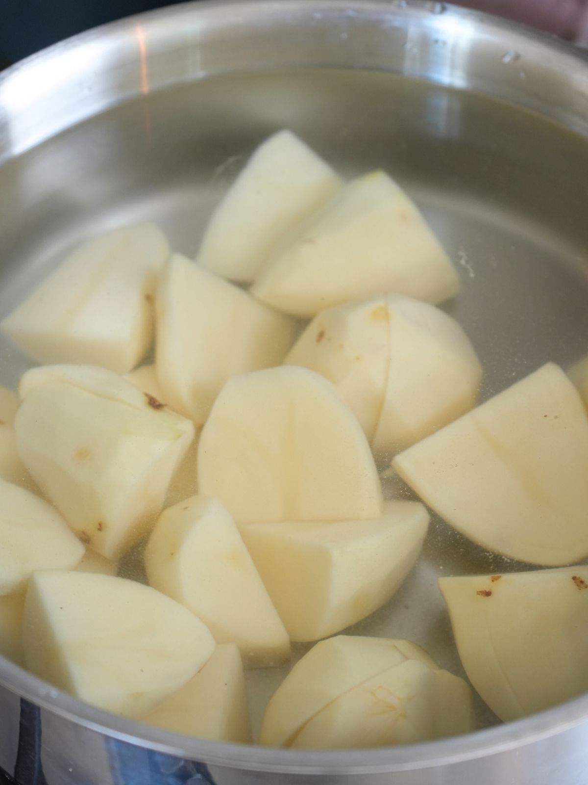 Potatoes in a pot of water.