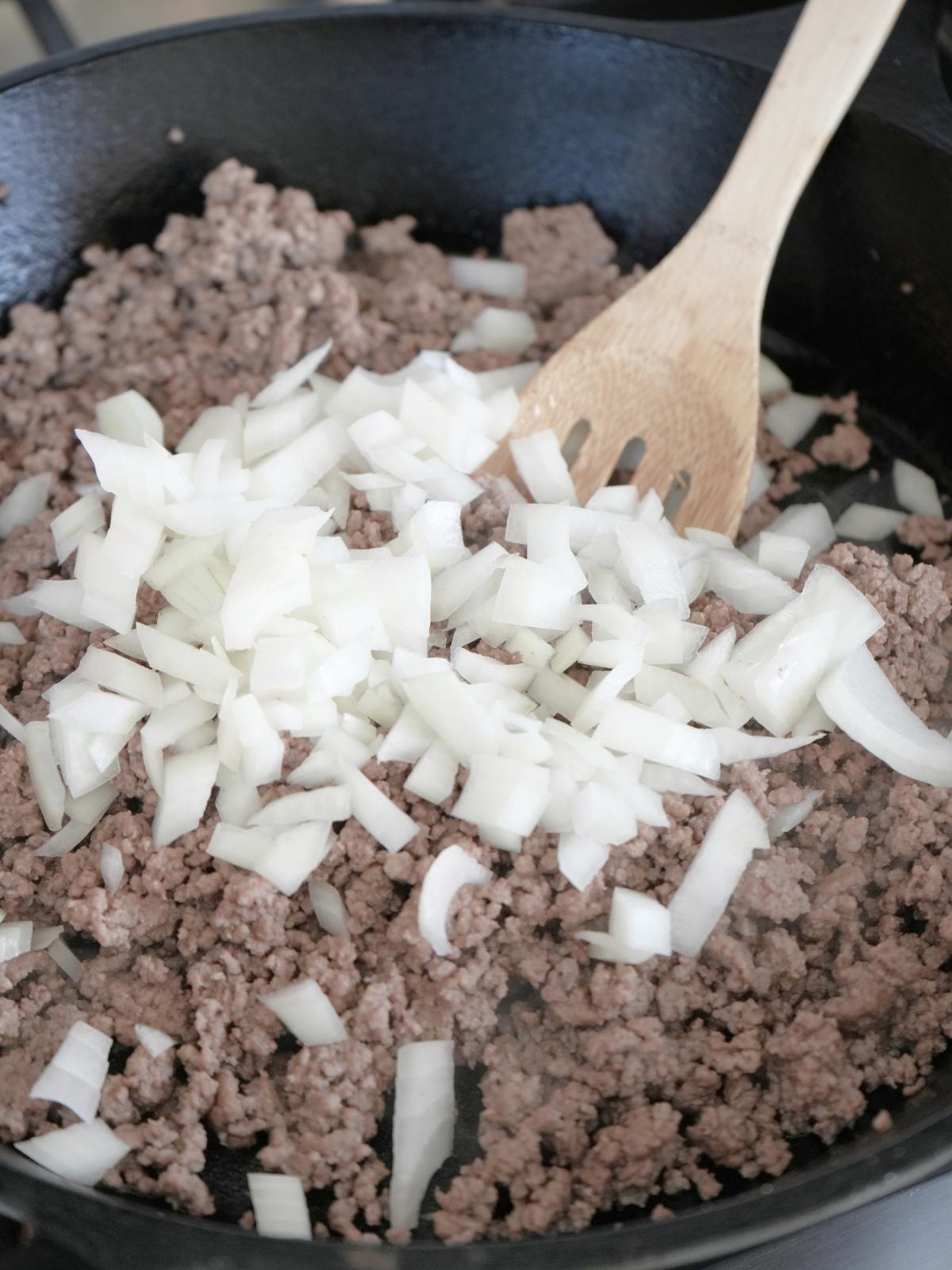 Browned ground beef topped with chopped onions.
