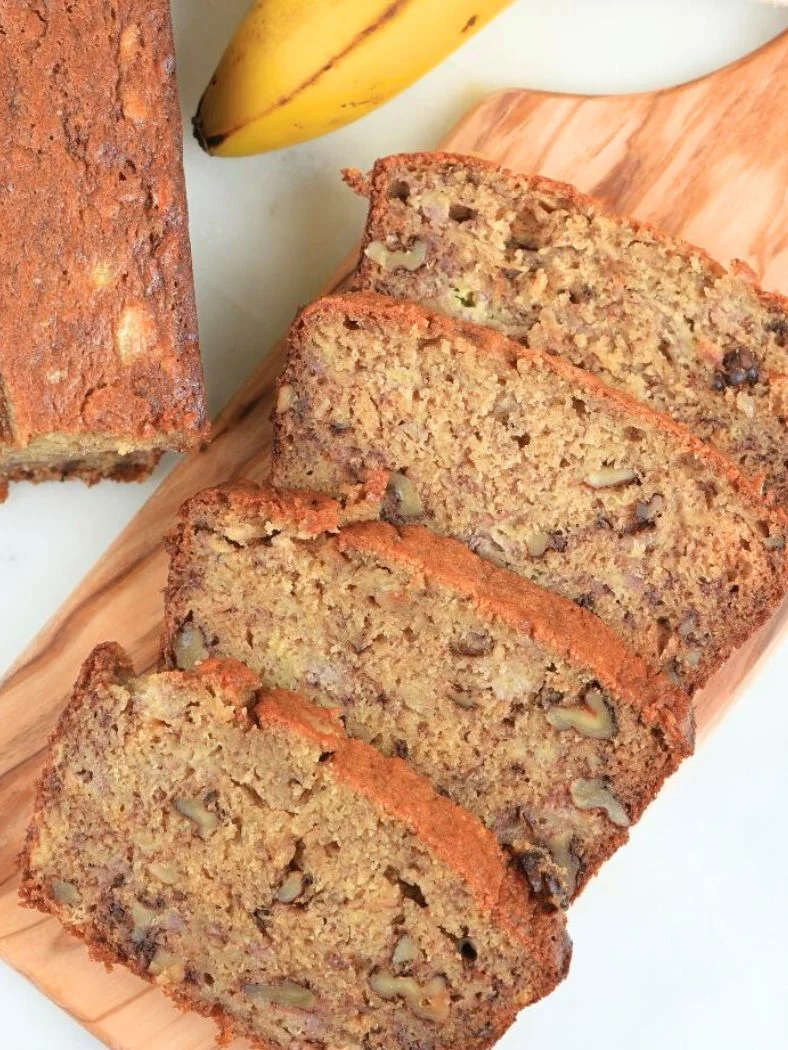 Slices of sourdough banana bread on a wood tray