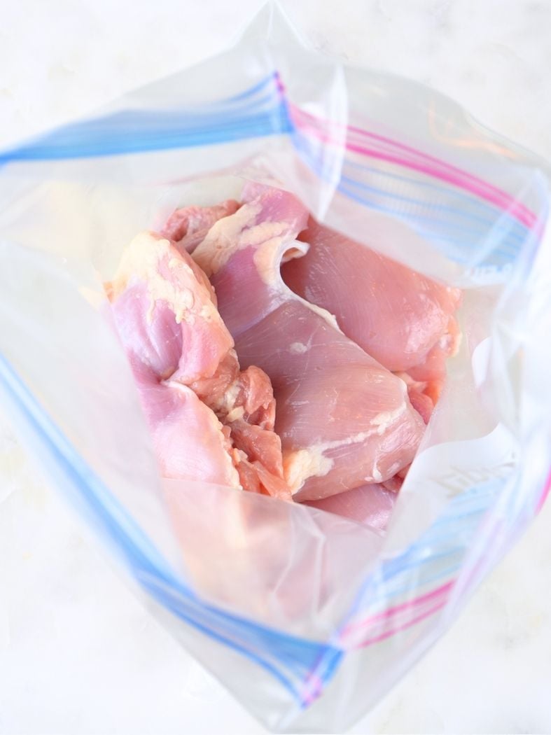 A freezer bag with chicken thighs inside