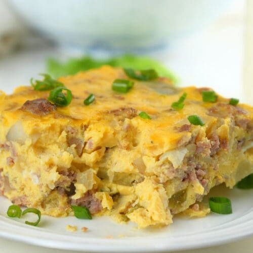Close up of a slice of slow cooker breakfast casserole on a white plate
