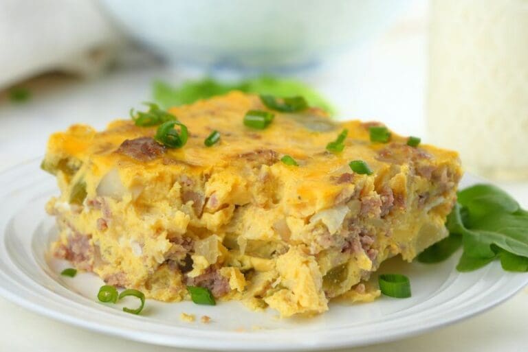 Close up of a slice of slow cooker breakfast casserole on a white plate