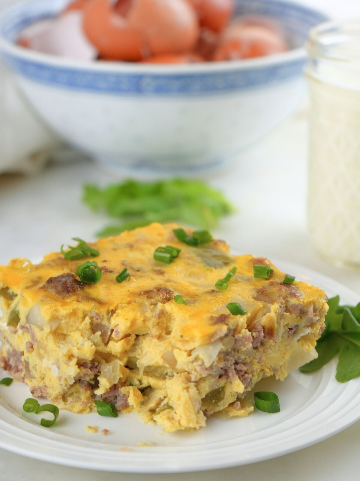 A slice of slow cooker breakfast casserole on a white plate.