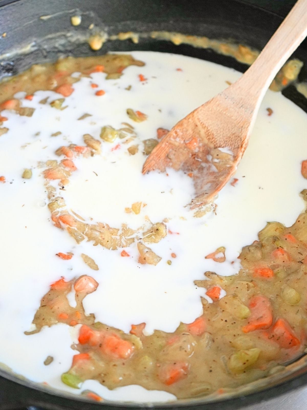 Milk poured into pot pie filling.