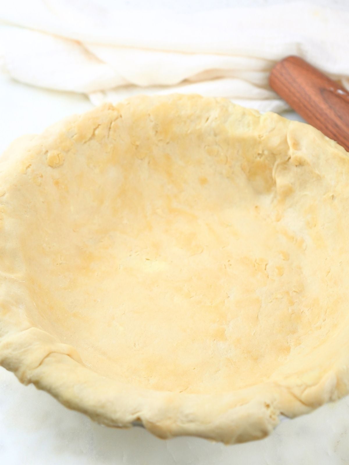 Pie crust rolled out and placed in a pie dish.