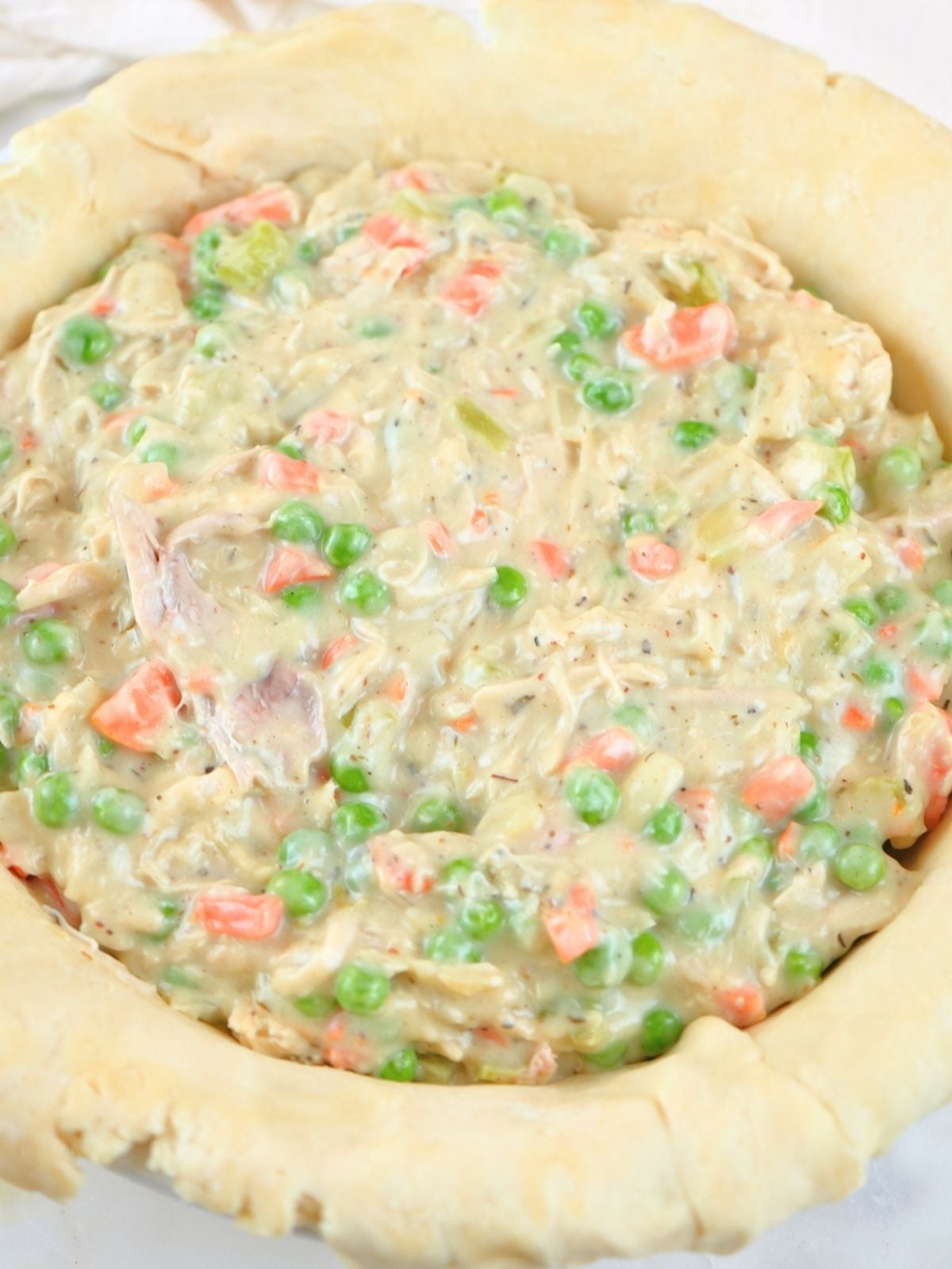 Pot pie filling in a unbaked pie crust.