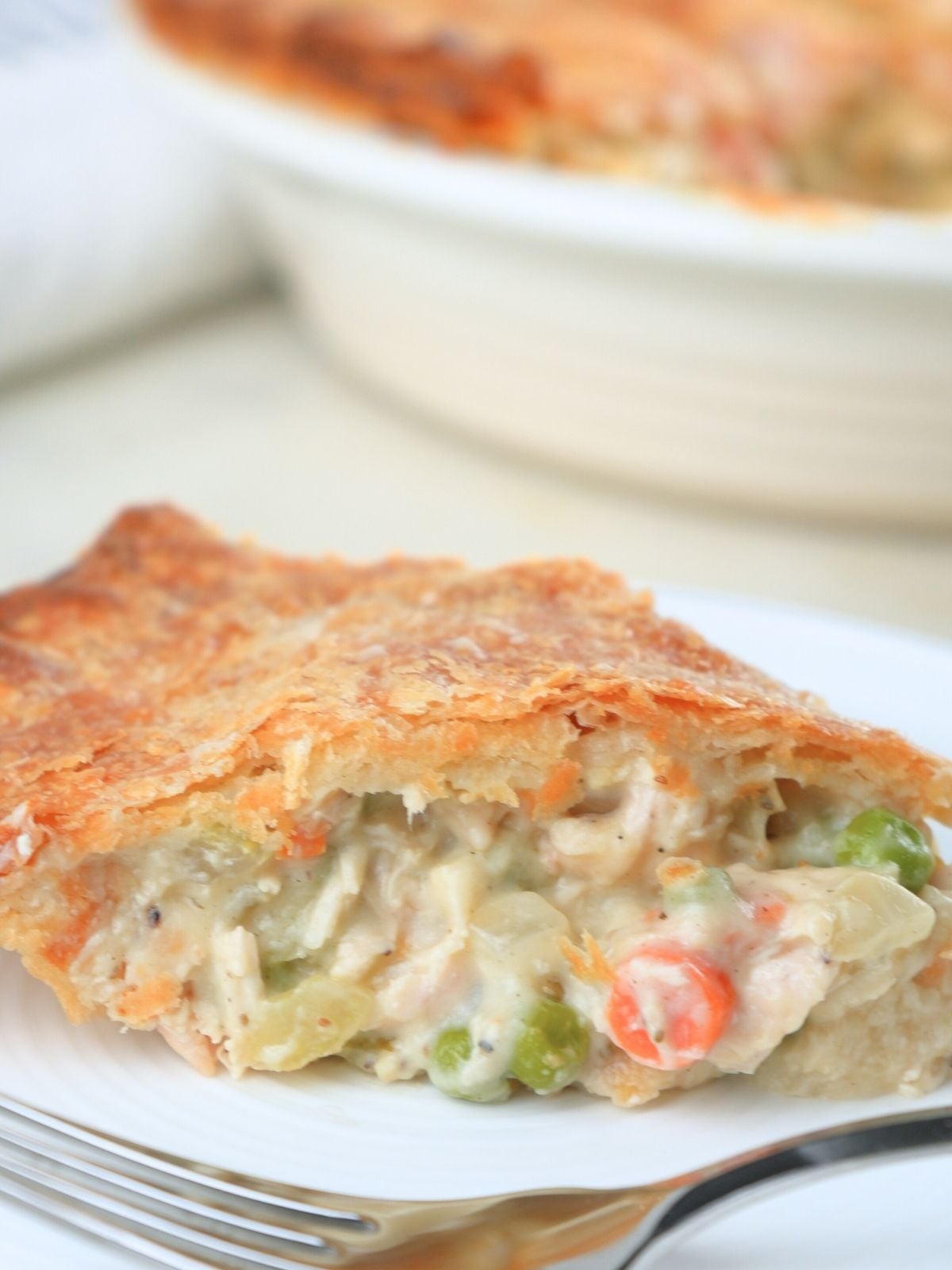 Sourdough chicken pot pie on a plate with a fork.