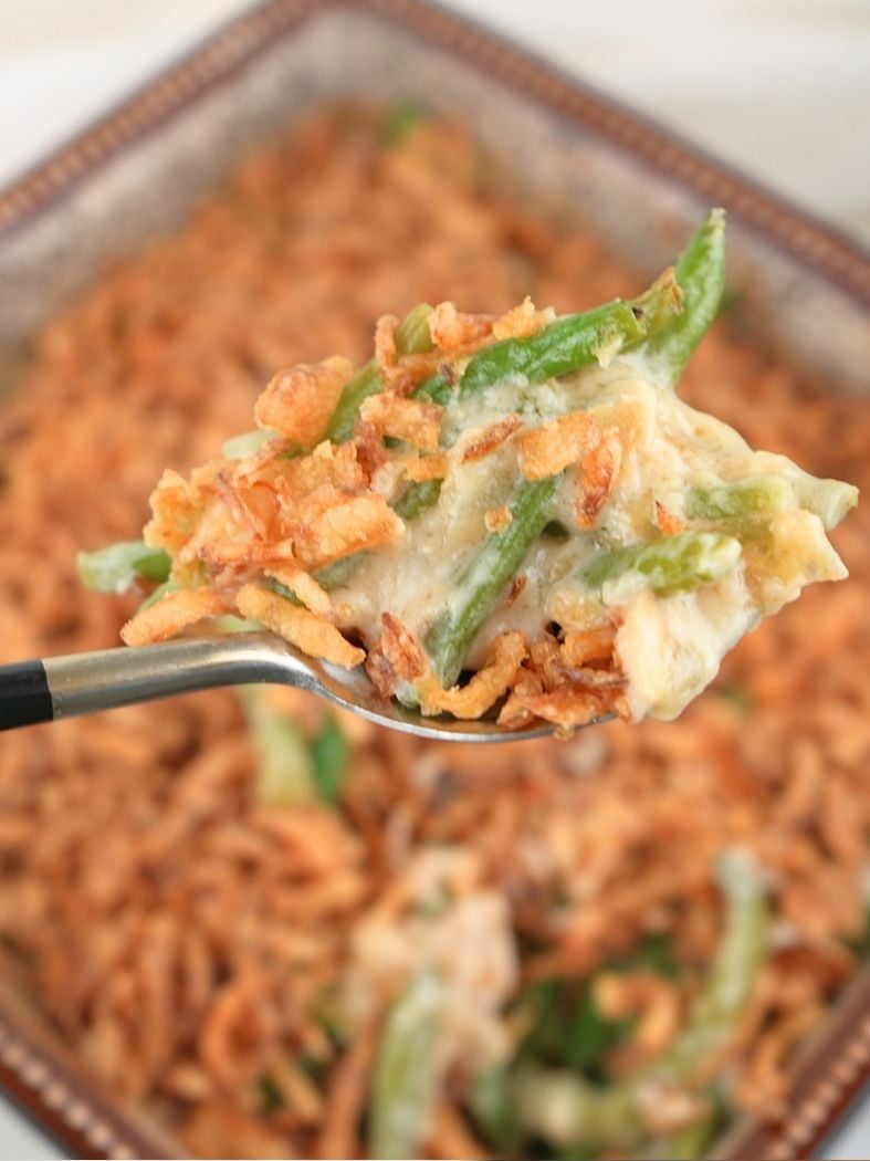 A spoonful of caramelized onion green bean casserole