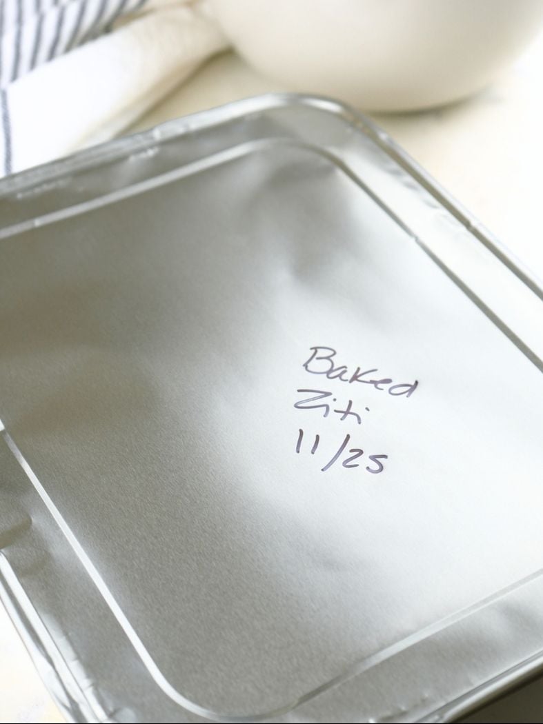 A foil pan and lid labeled "Baked Ziti"