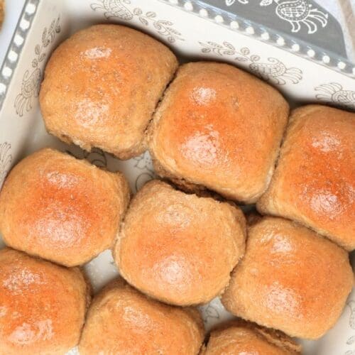 An overhead view of fresh-milled dinner rolls in a decorative baking dish