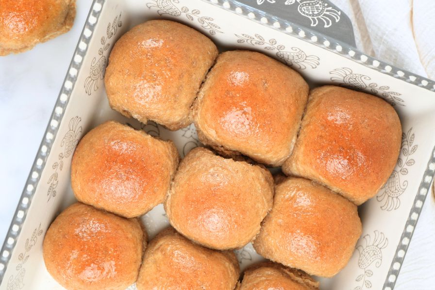 An overhead view of fresh-milled dinner rolls in a decorative baking dish