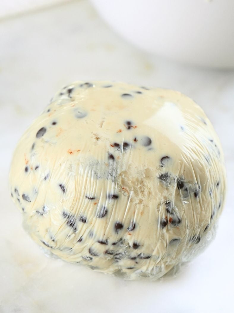 Chocolate chip cheese ball shaped and wrapped in plastic wrap