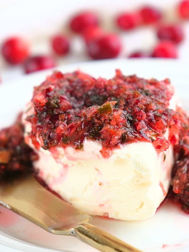 A close up of cranberry salsa over cream cheese
