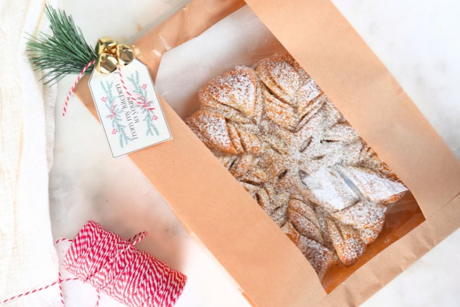 A sourdough cinnamon snowflake a holiday packaging, shown with bakers twine