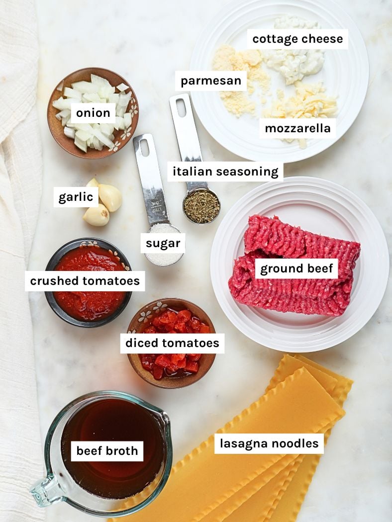 Slow cooker lasagna soup ingredients displayed and labeled