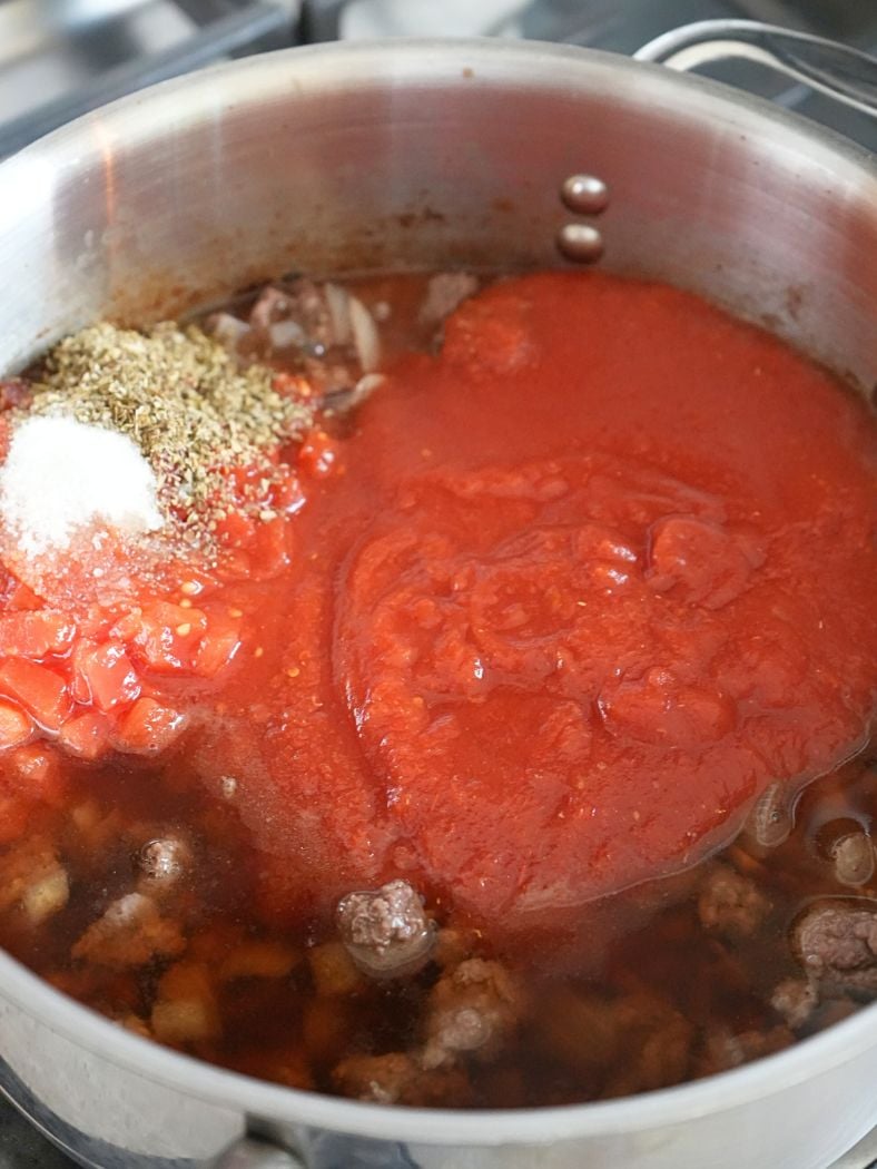 Lasagna soup ingredients in a skillet