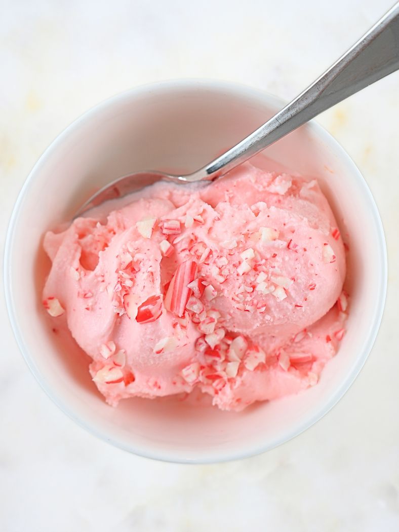 An overhead view of a bowl of peppermint stick ice cream with crush candy canes