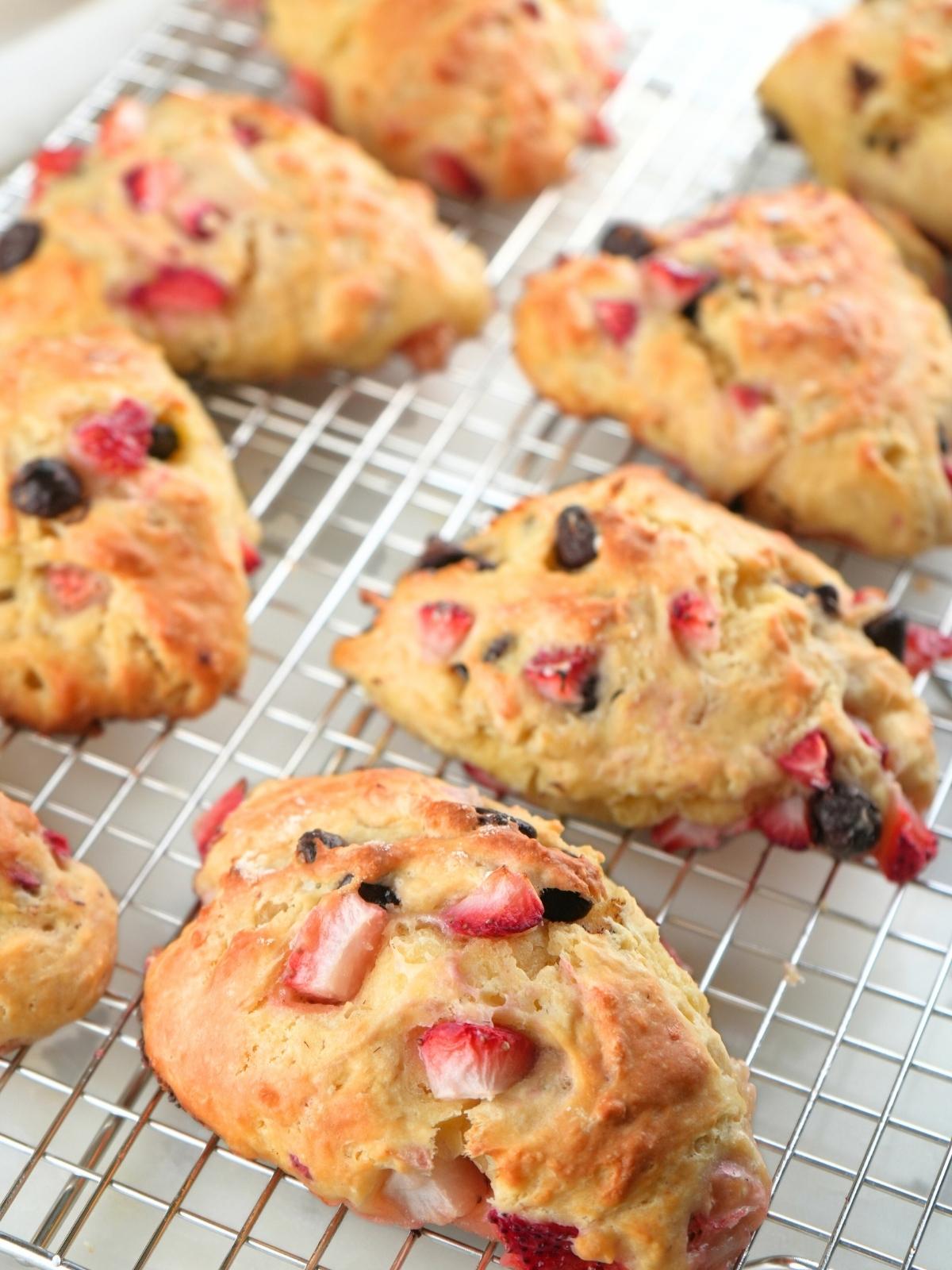 Strawberry chocolate chip scones on a wire rack.