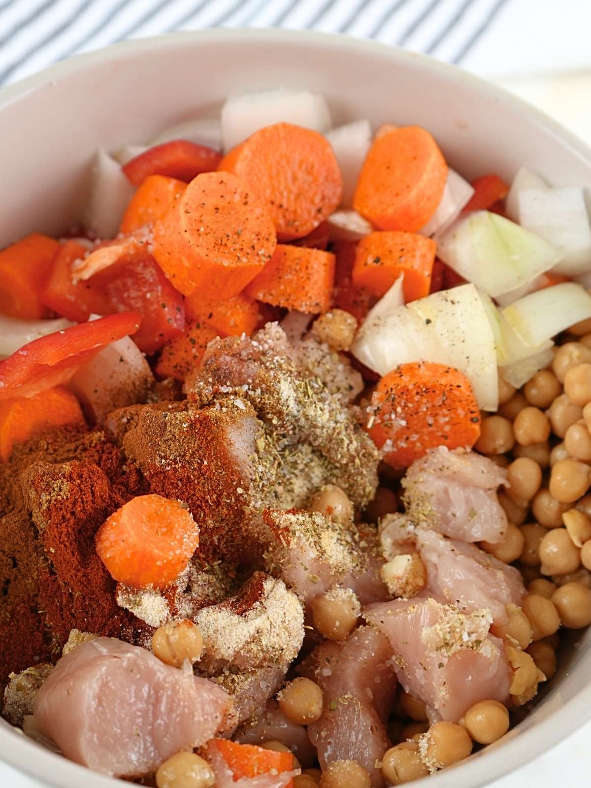 Chicken shawarma sheet pan ingredients in a mixing bowl.