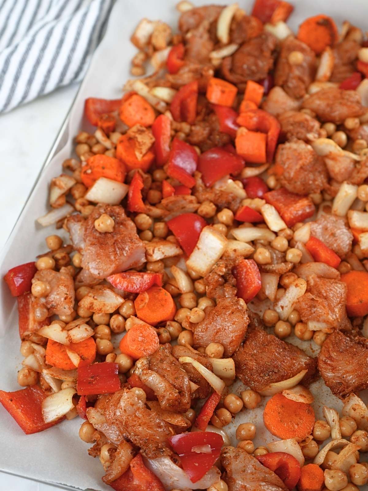 Chicken shawarma sheet pan ingredients on a baking sheet.