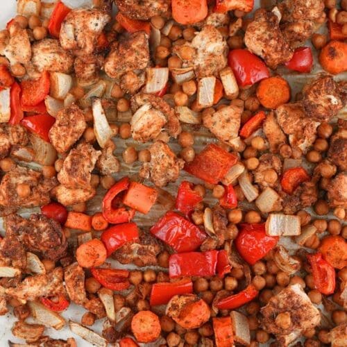 Chicken shawarma sheet pan dinner scattered on a baking sheet.