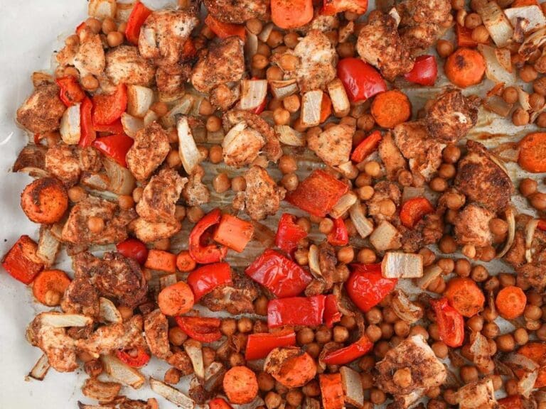 Chicken shawarma sheet pan dinner scattered on a baking sheet.