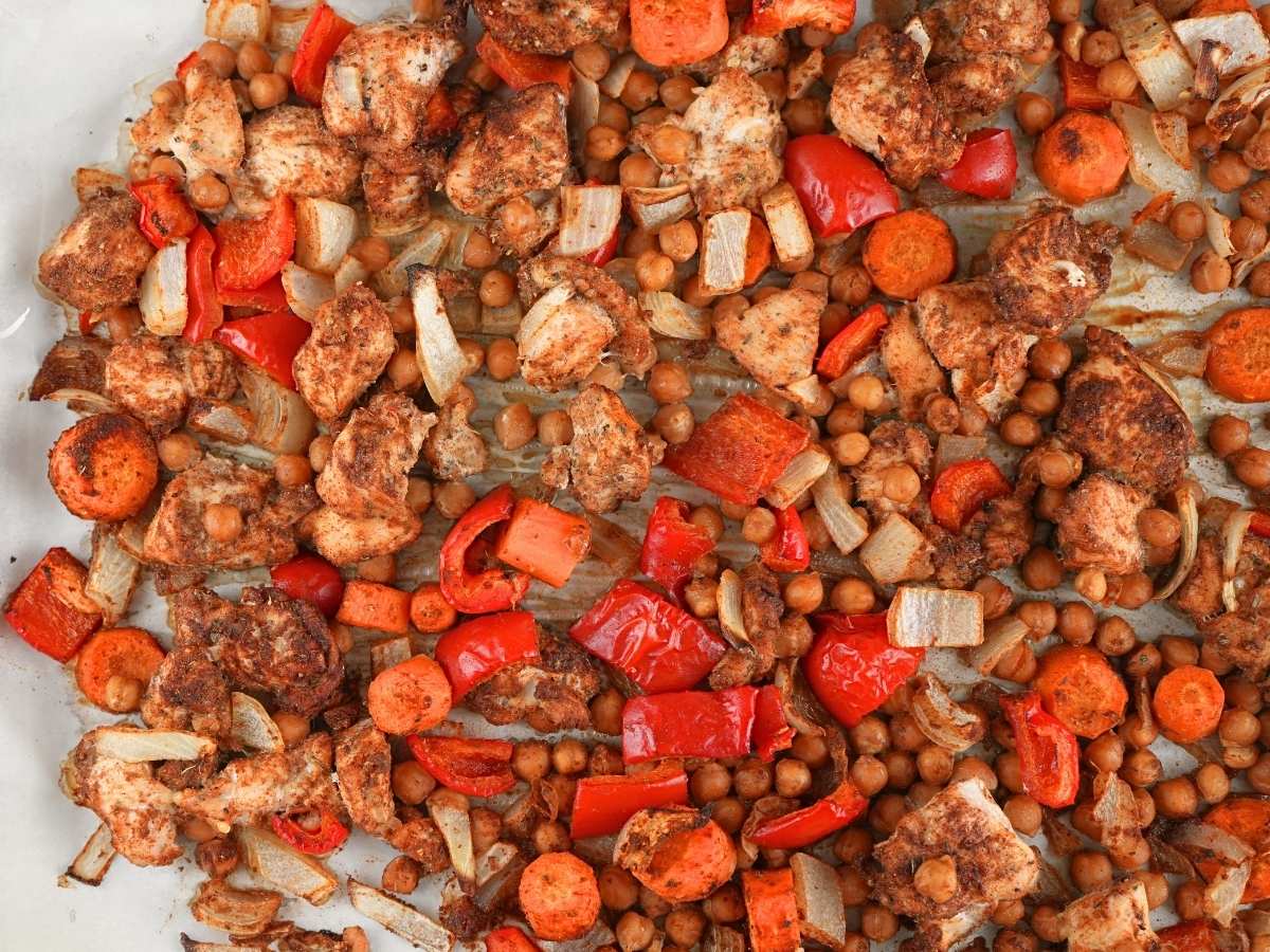 Chicken shawarma sheet pan dinner scattered on a baking sheet.