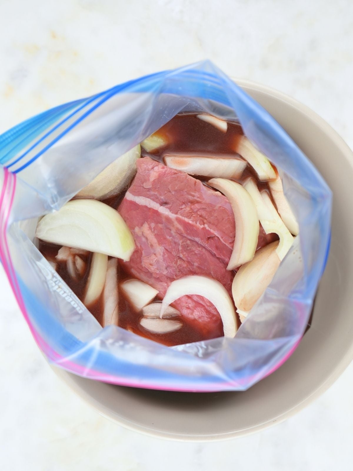 Slow cooker French dip ingredients in a freezer bag.