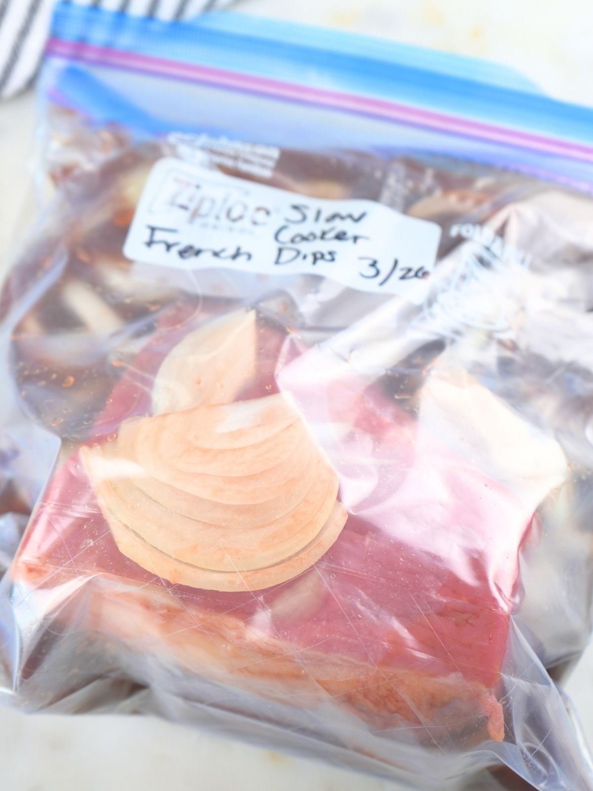 French dip freezer meal in a labeled freezer bag.