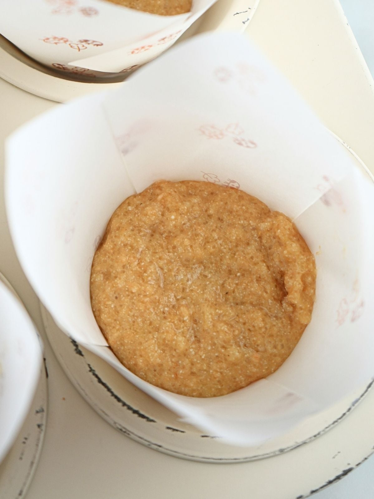 A spoonful of fresh-milled muffin batter in a muffin liner.