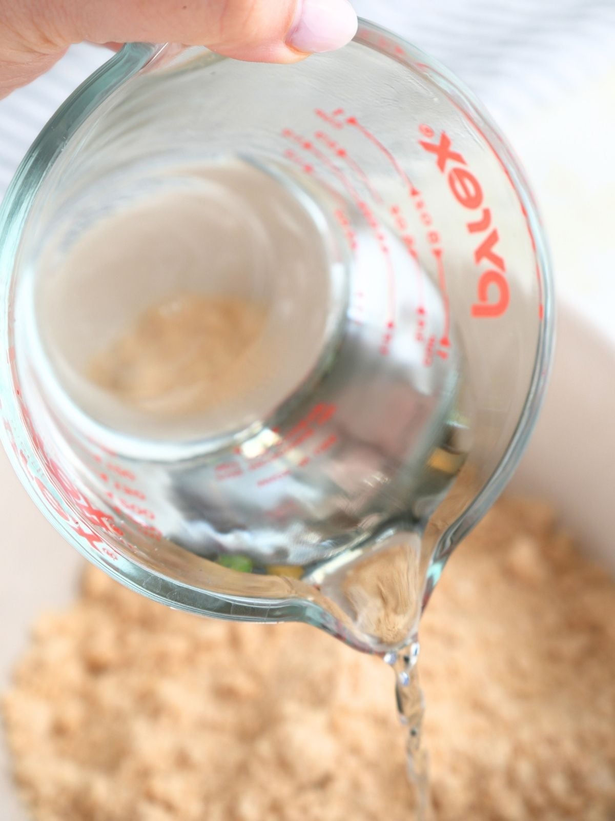 Water being poured into fresh milled tortilla mixture.