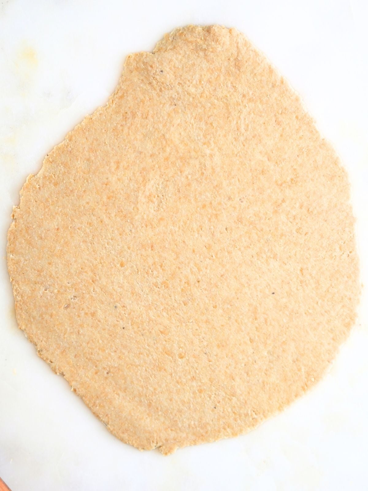 Dough rolled into a flat tortilla shape.