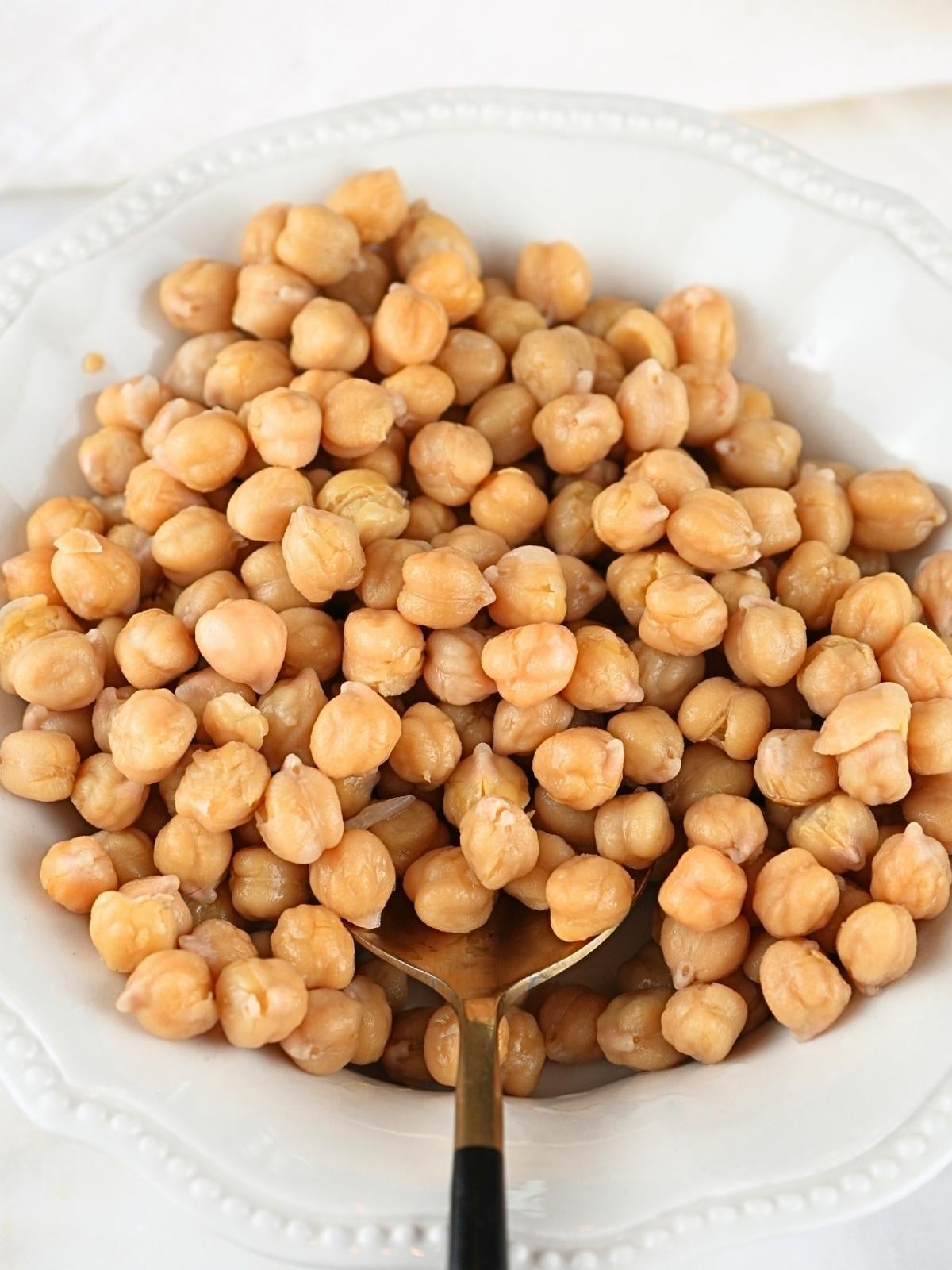 Instant Pot Chickpeas in a bowl in a serving spoon.