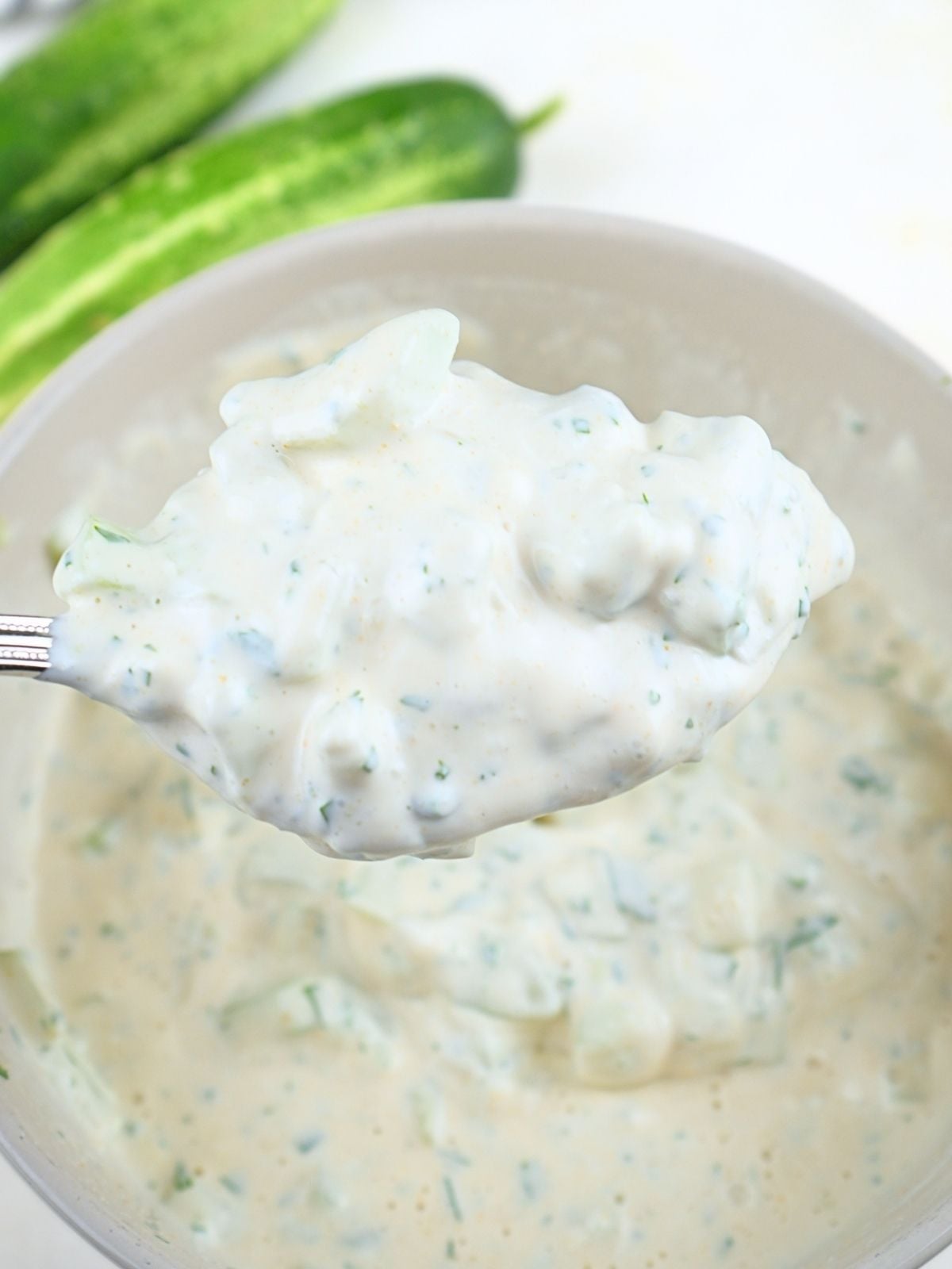 Cucumber ranch dressing on a spoon.