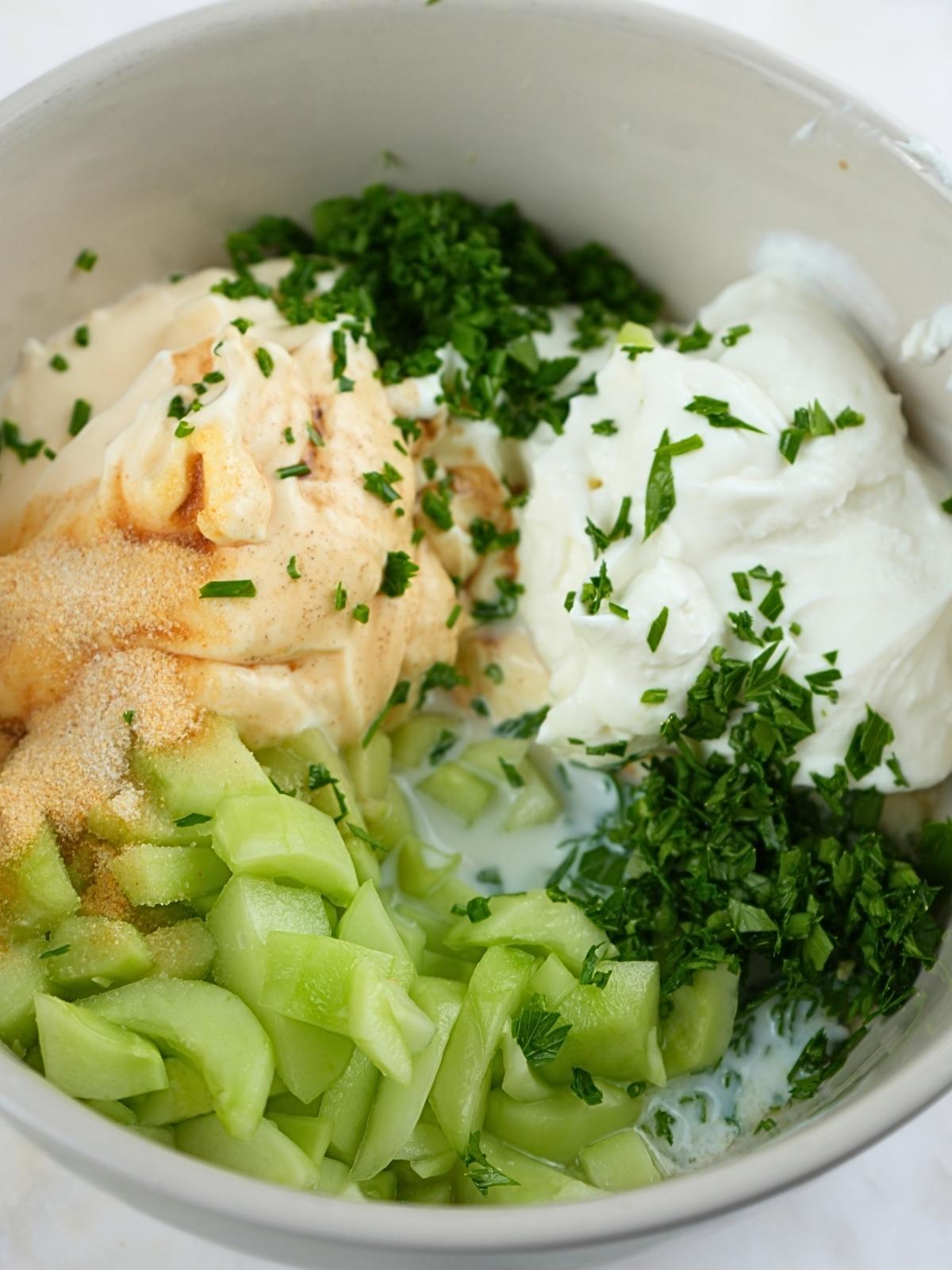 Greek yogurt cucumber ranch ingredients in a bowl.