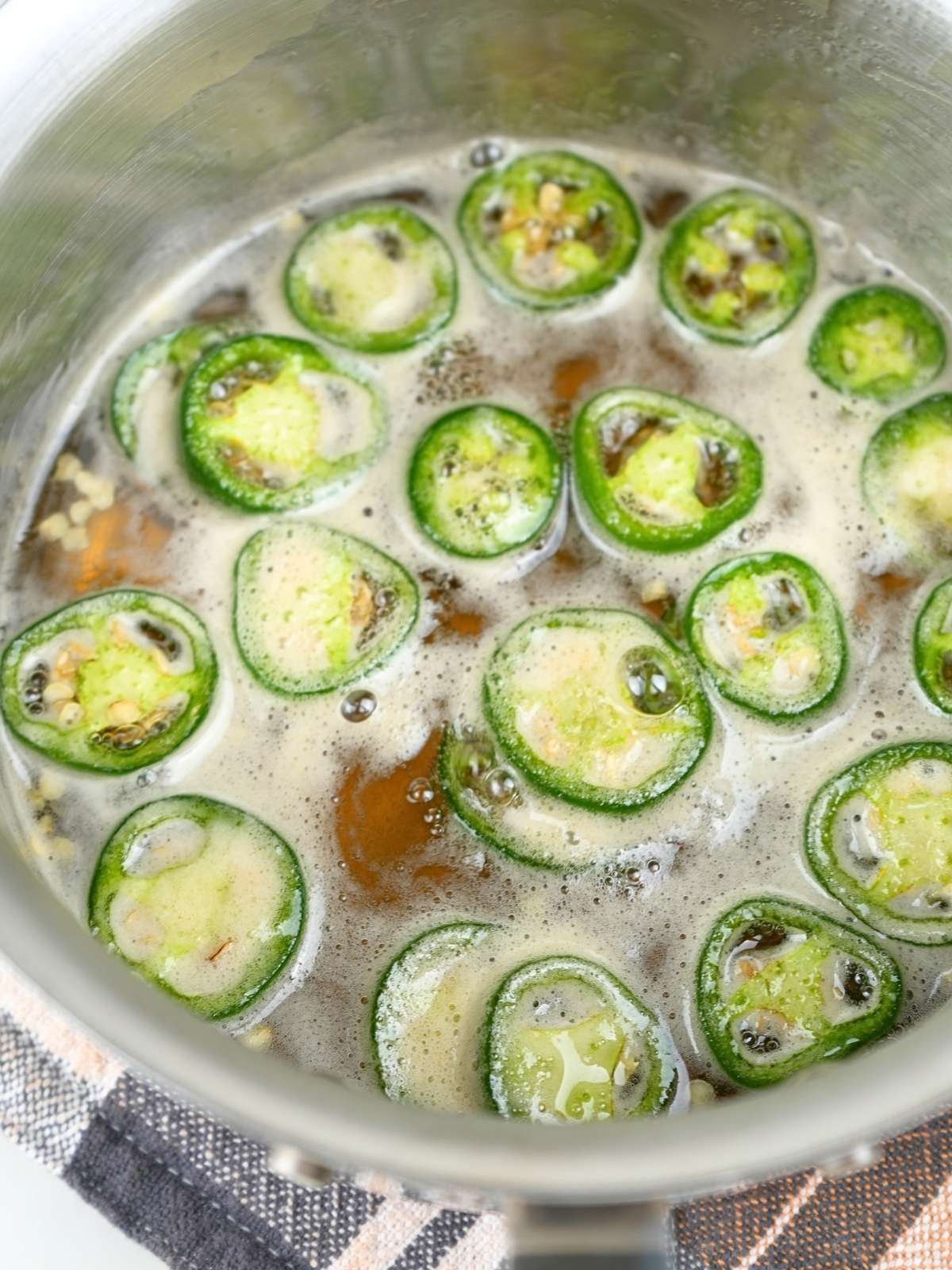 Jalapeño hot honey simmering in a pot.