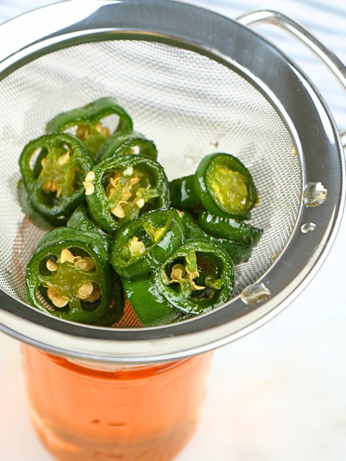 Jalapeños strained through a sieve.