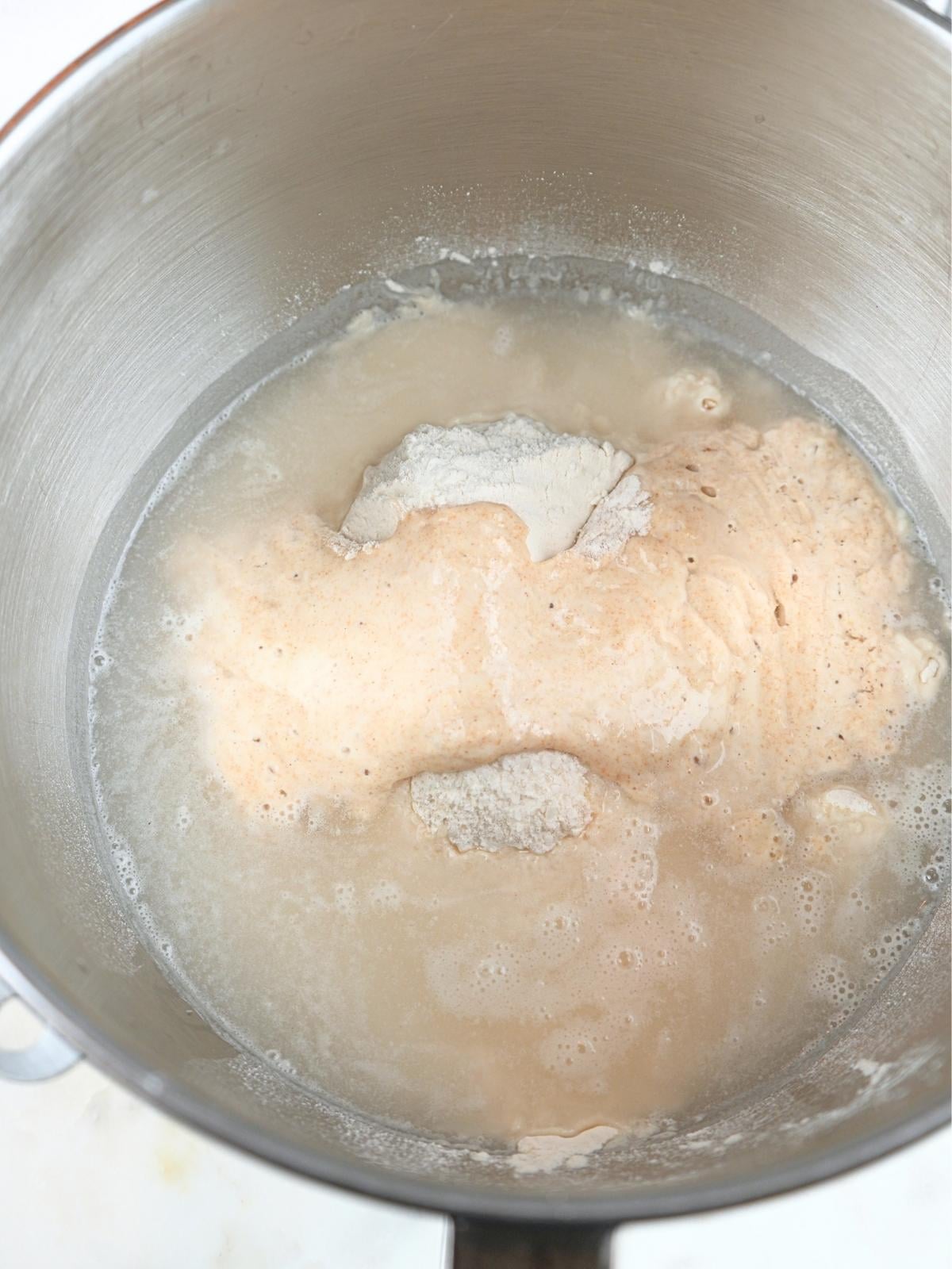 Baguette ingredients in a stand mixer bowl.