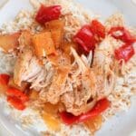 Sweet and sour chicken freezer plated with white rice and black pepper.