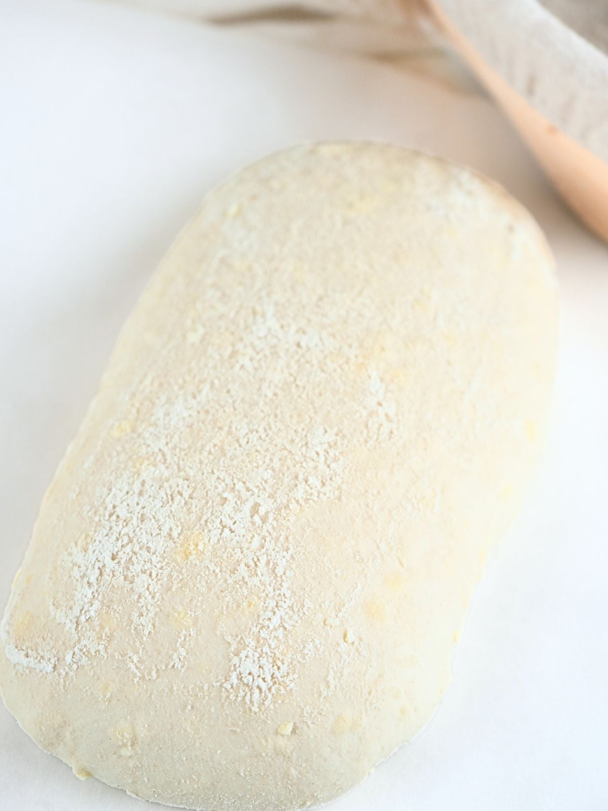 Proofed dough on a piece of parchment paper.