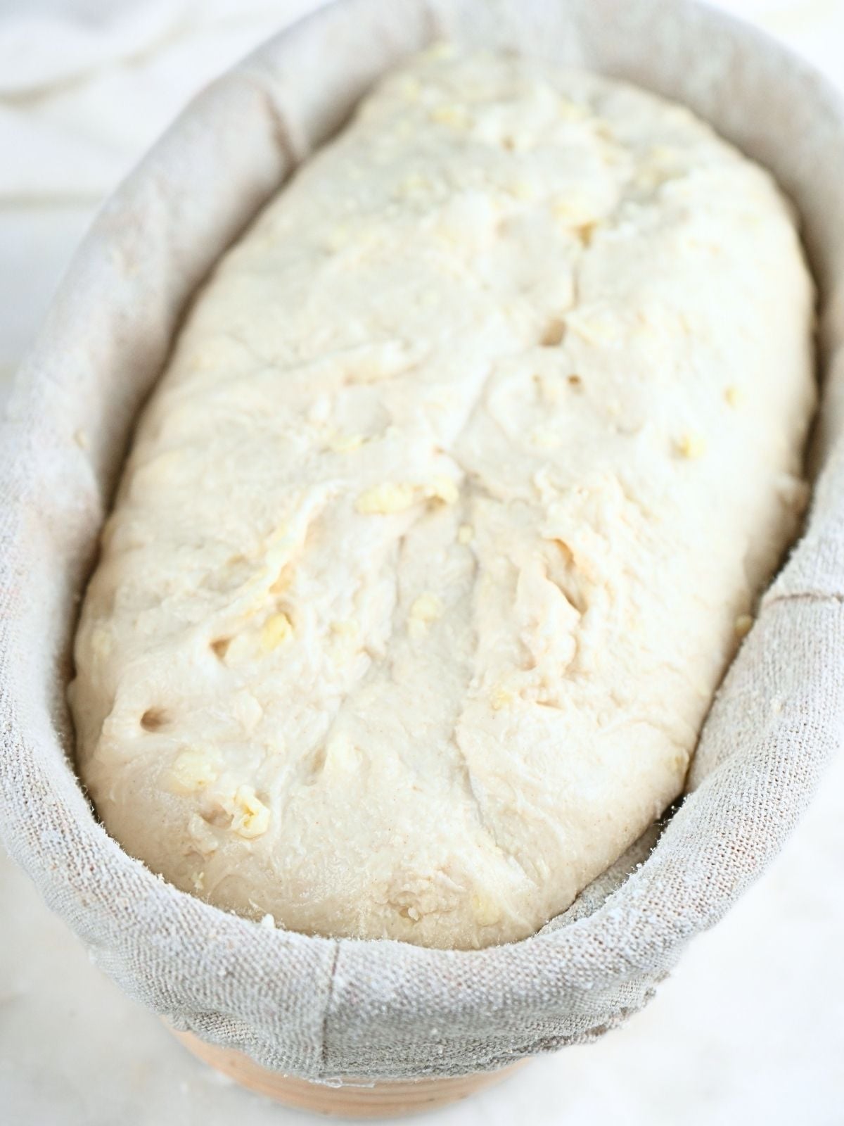 Sourdough croissant bread dough in a banneton.