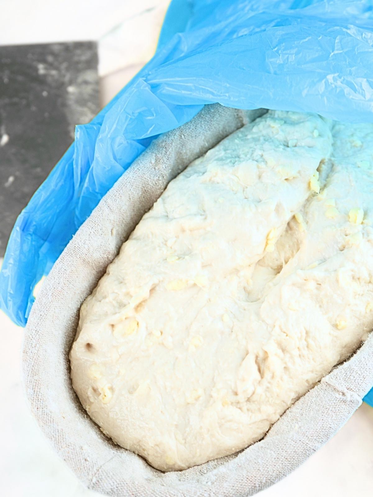 Shaped dough covered with a plastic bag.